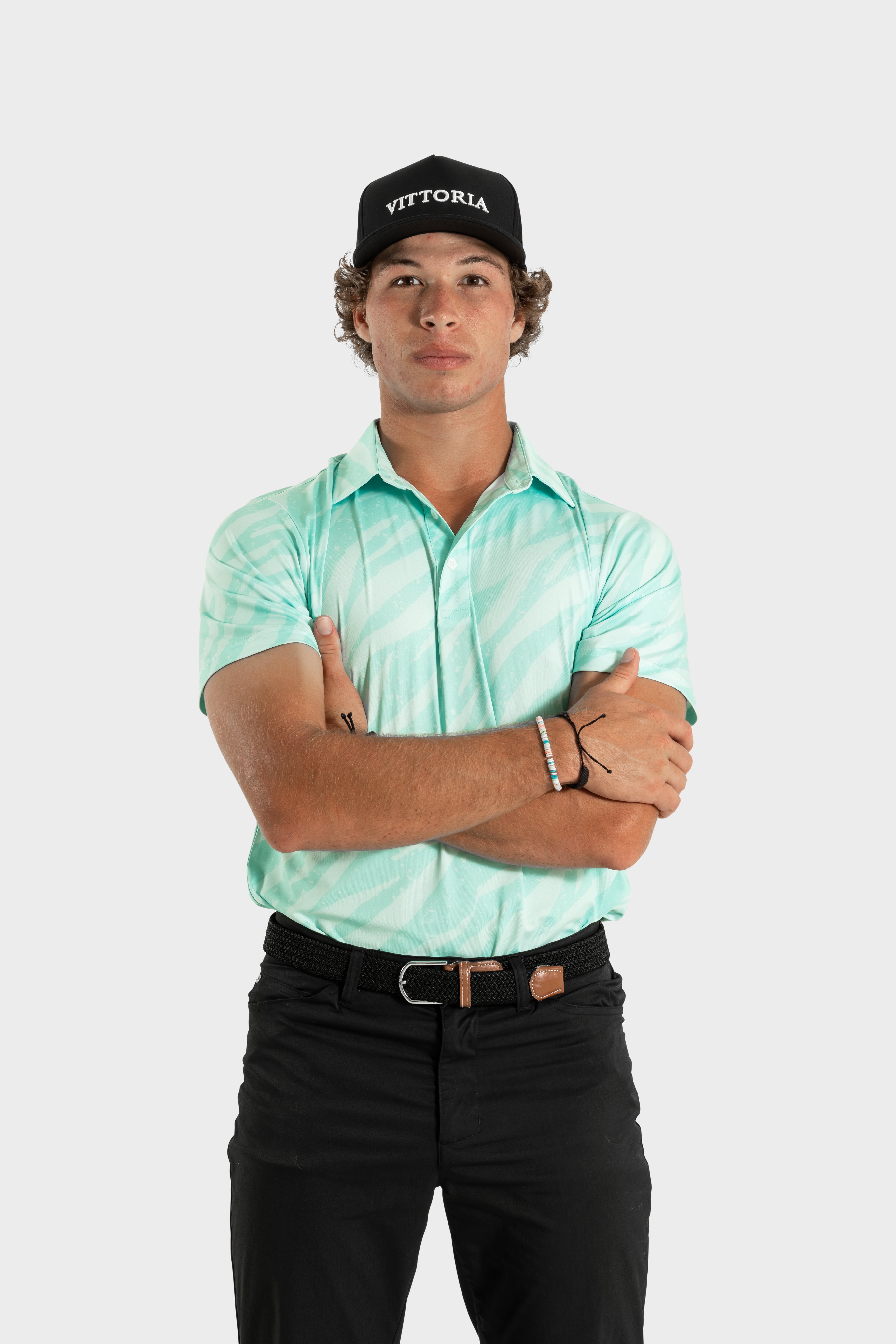 Man wearing The TigerMint mint-green breathable polo shirt with black pants and cap
