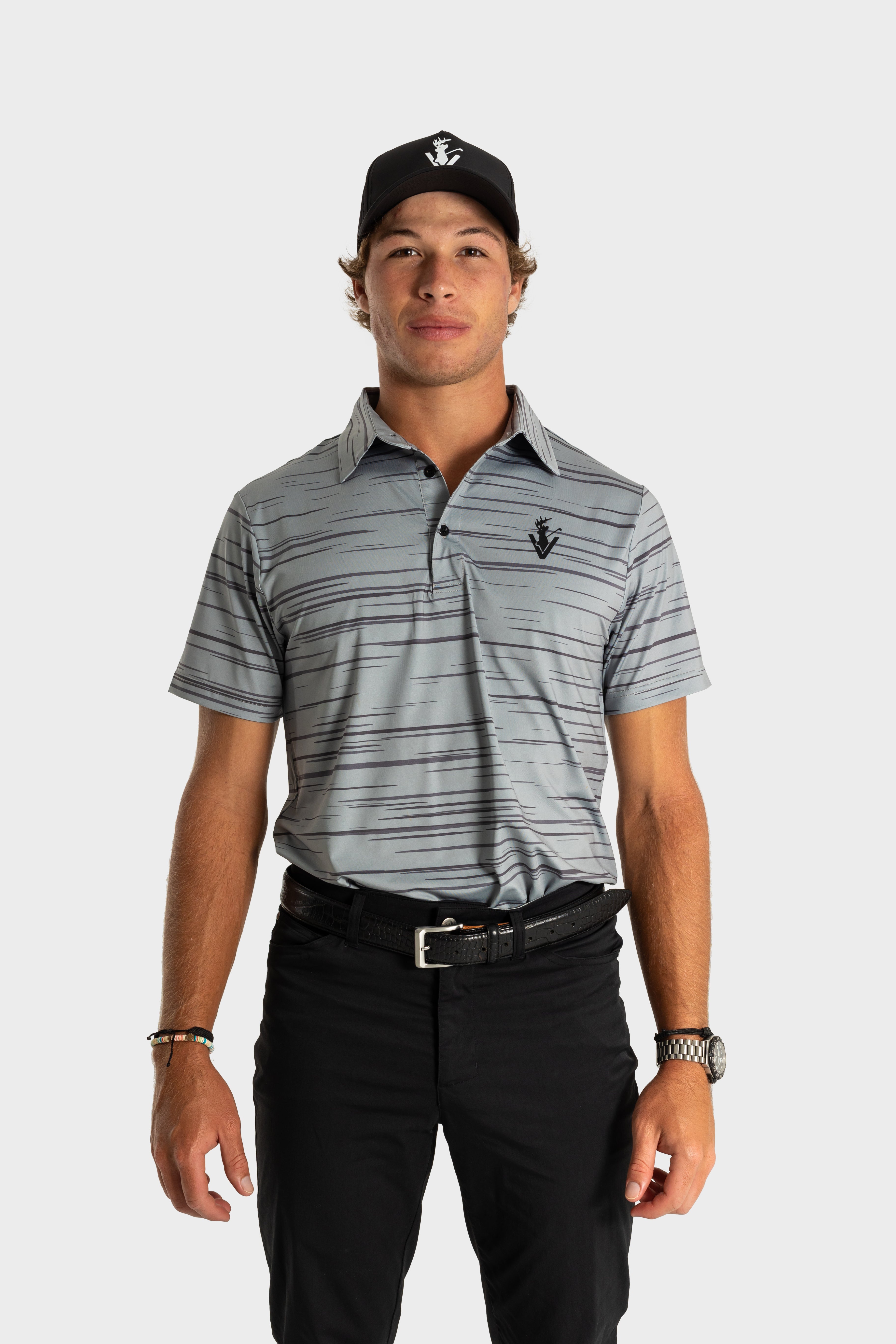 The Gray polo shirt by VittoriaGolfco worn by male model with black cap and black pants