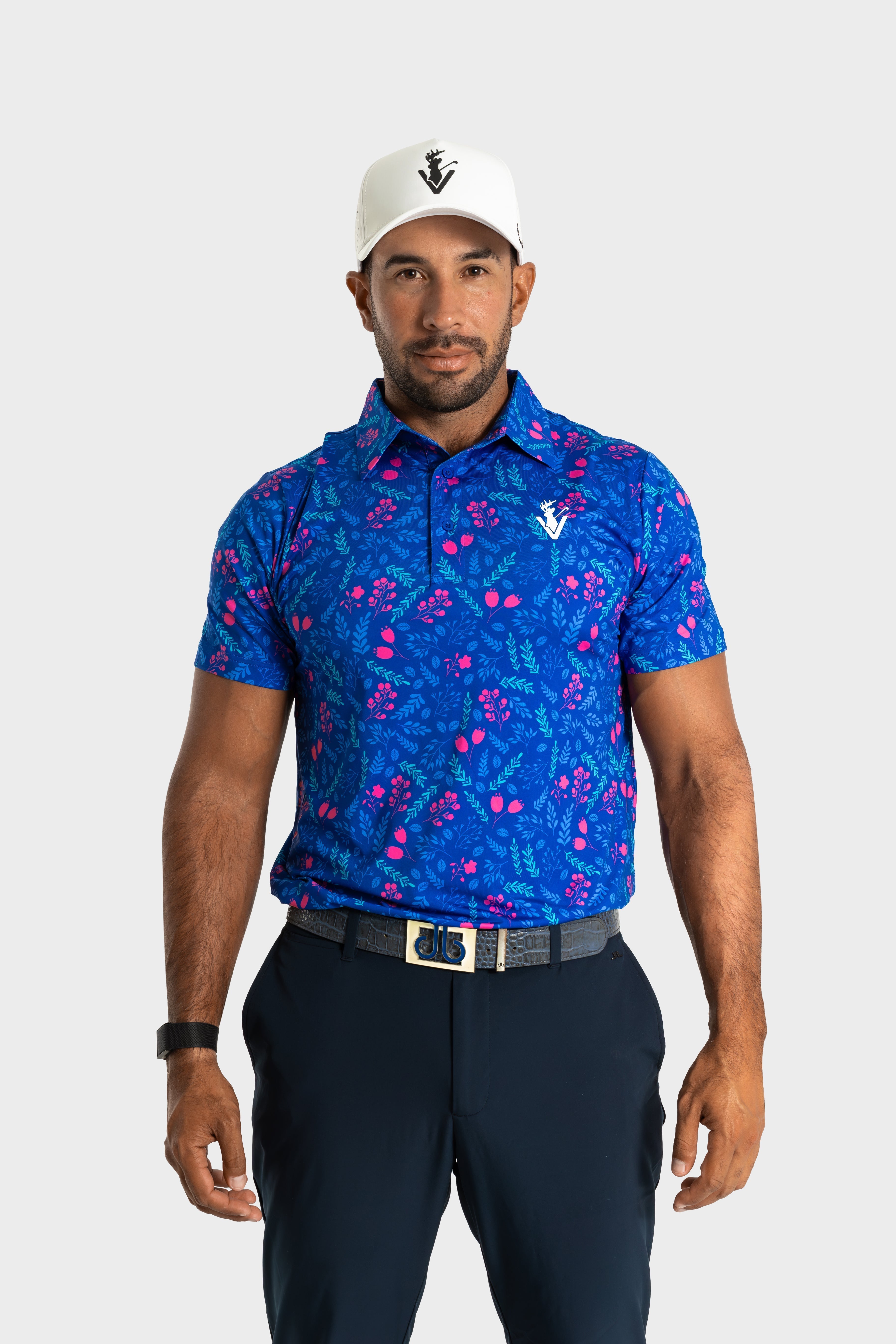 Man wearing The Gatsby polo by VittoriaGolfco in blue with pink floral pattern and white cap