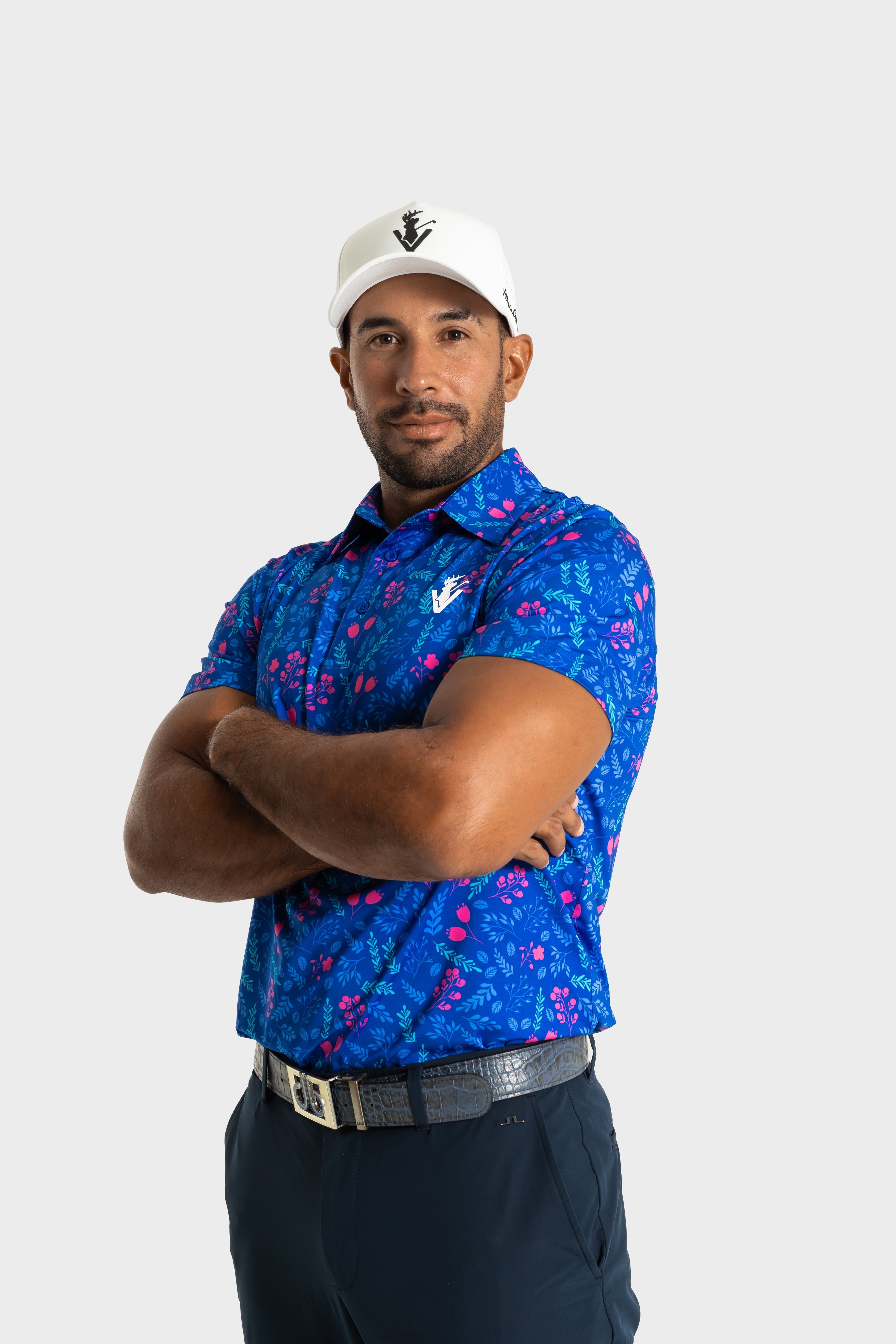 The Gatsby polo by VittoriaGolfco in blue floral pattern worn by male model with white cap