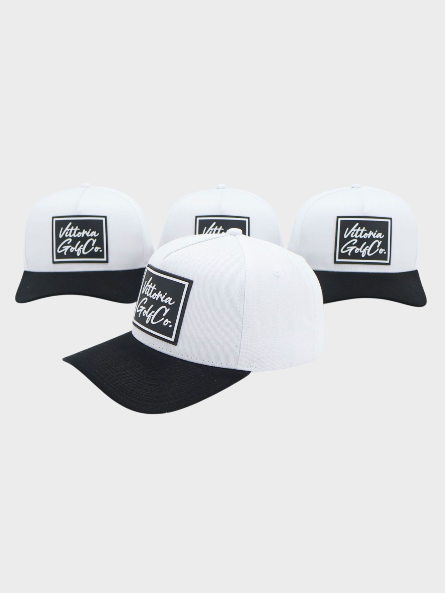 Three white and black two tone cotton hats with Vittoria Golf Co. logo on the front, adjustable snapback strap, and classic design