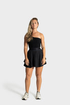 Woman wearing black Blossom golf skirt with comfortable fit and built-in compression shorts
