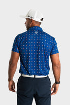 Man wearing blue textured knitted polo shirt from back with white cap and black pants