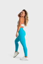 Woman wearing bright blue Sollevare leggings by VittoriaGolfCo with supportive, breathable fabric and stylish fit