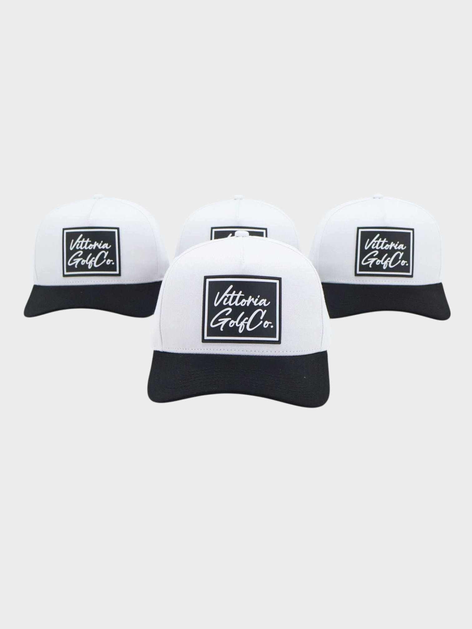 Set of four two-tone cotton golf hats with white crown, black brim, and Vittoria Golf Co. logo patch